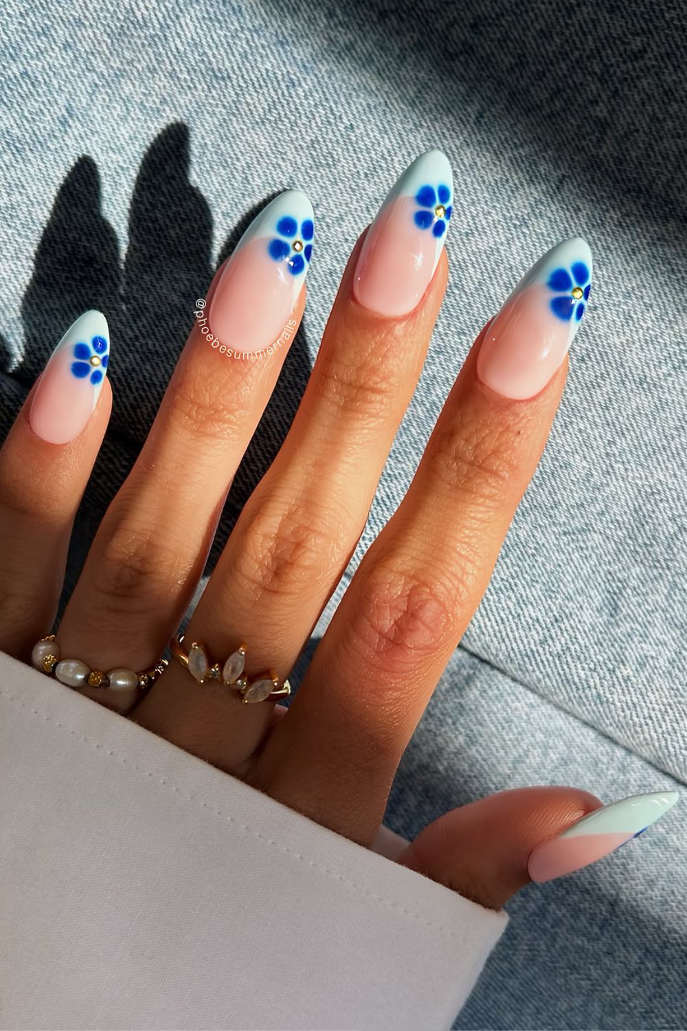 Light blue French mani with royal blue blooming florals