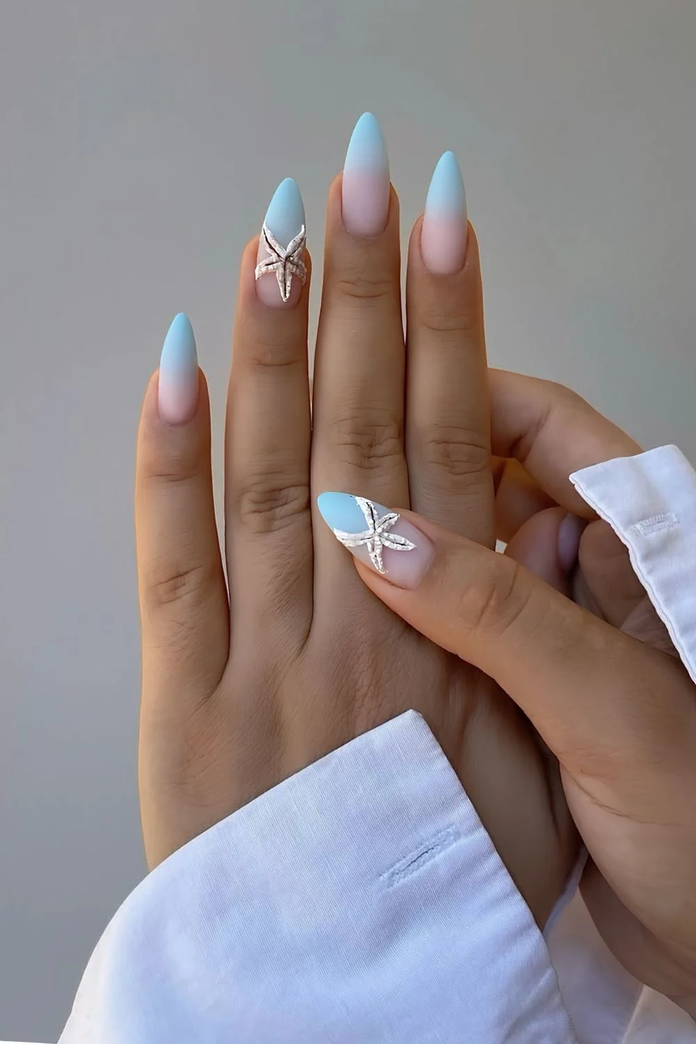 Matte light blue ombre French tips with starfish accents