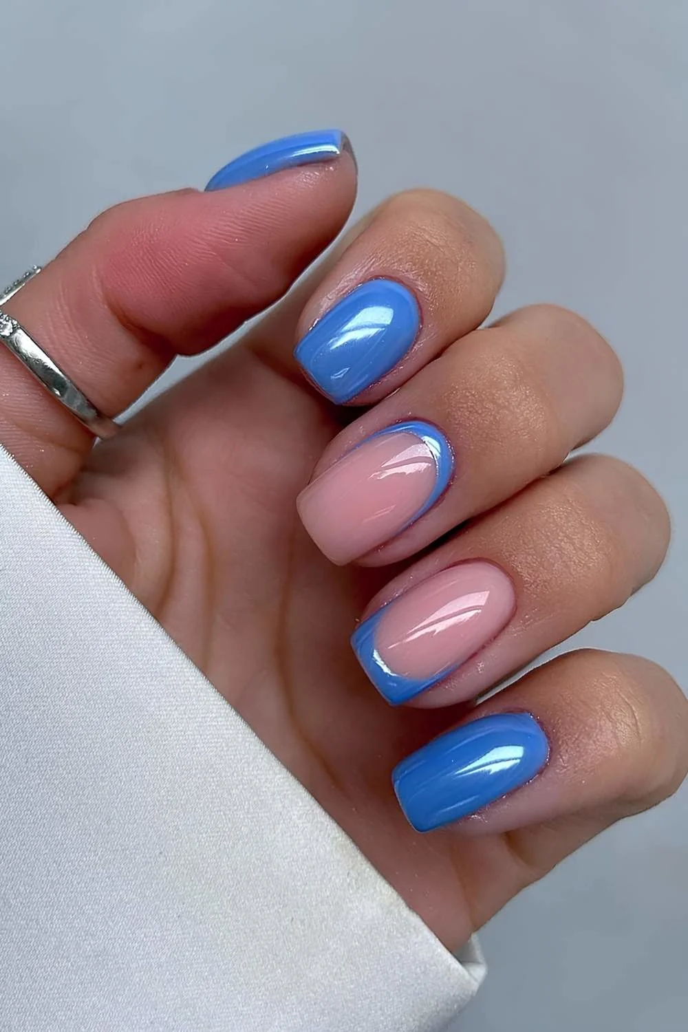 Mid blue chrome nails with accent French tips