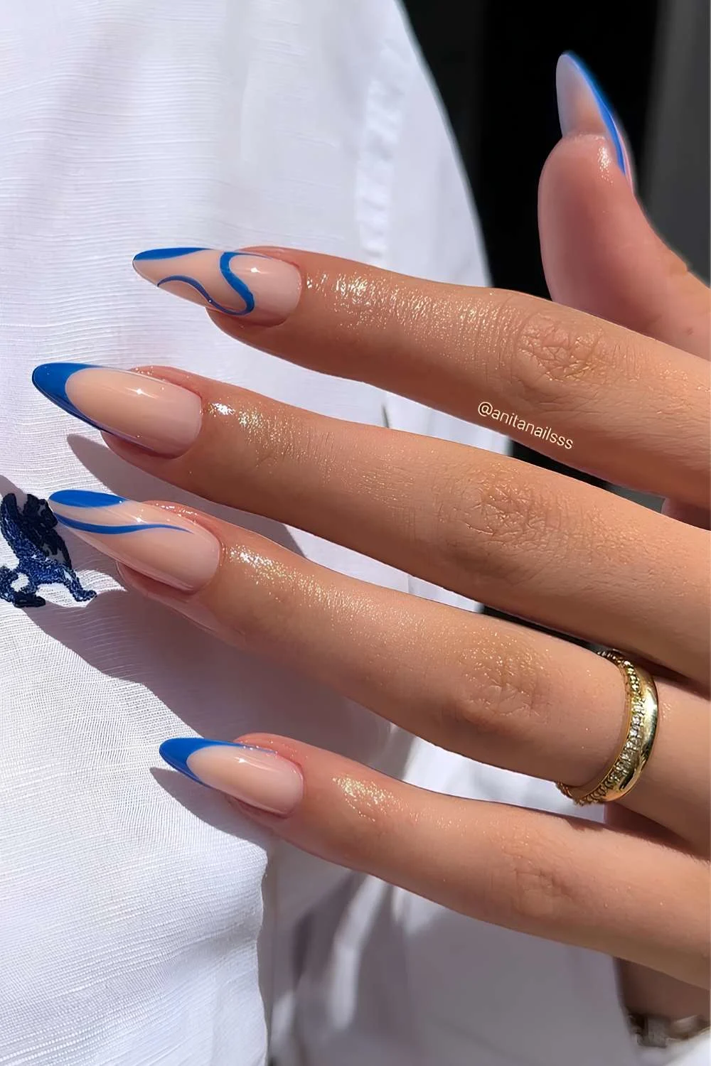 Milky nails with cobalt blue swirl art