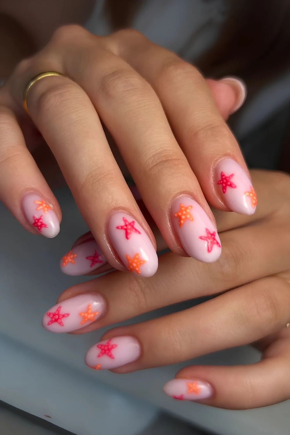 Milky pink with orange and pink starfish nail design