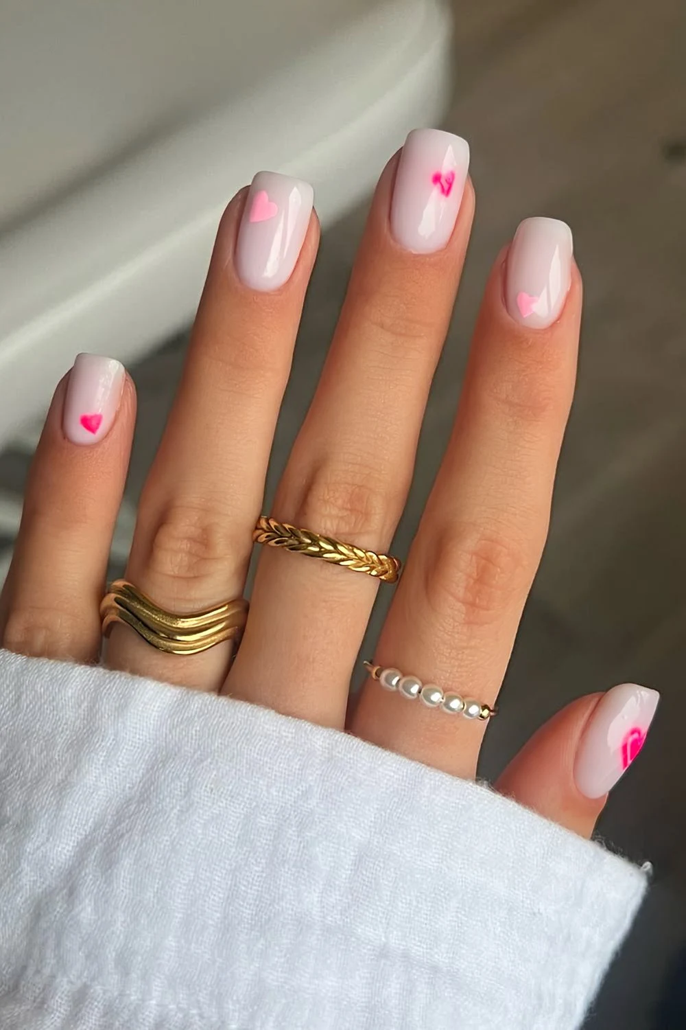 Milky white nails with pink hearts