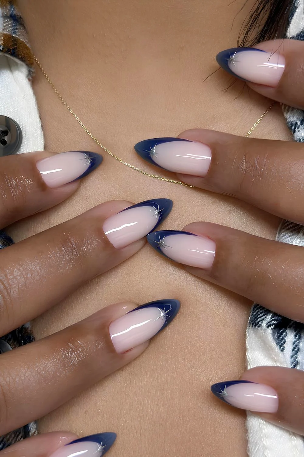 Navy blue French tip nails with silver star accents