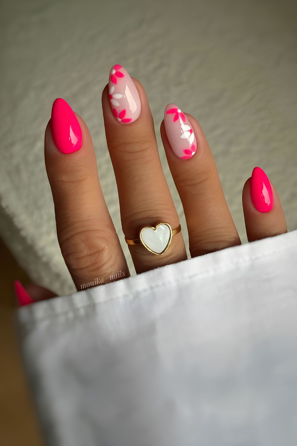 Neon pink nails with floral accents
