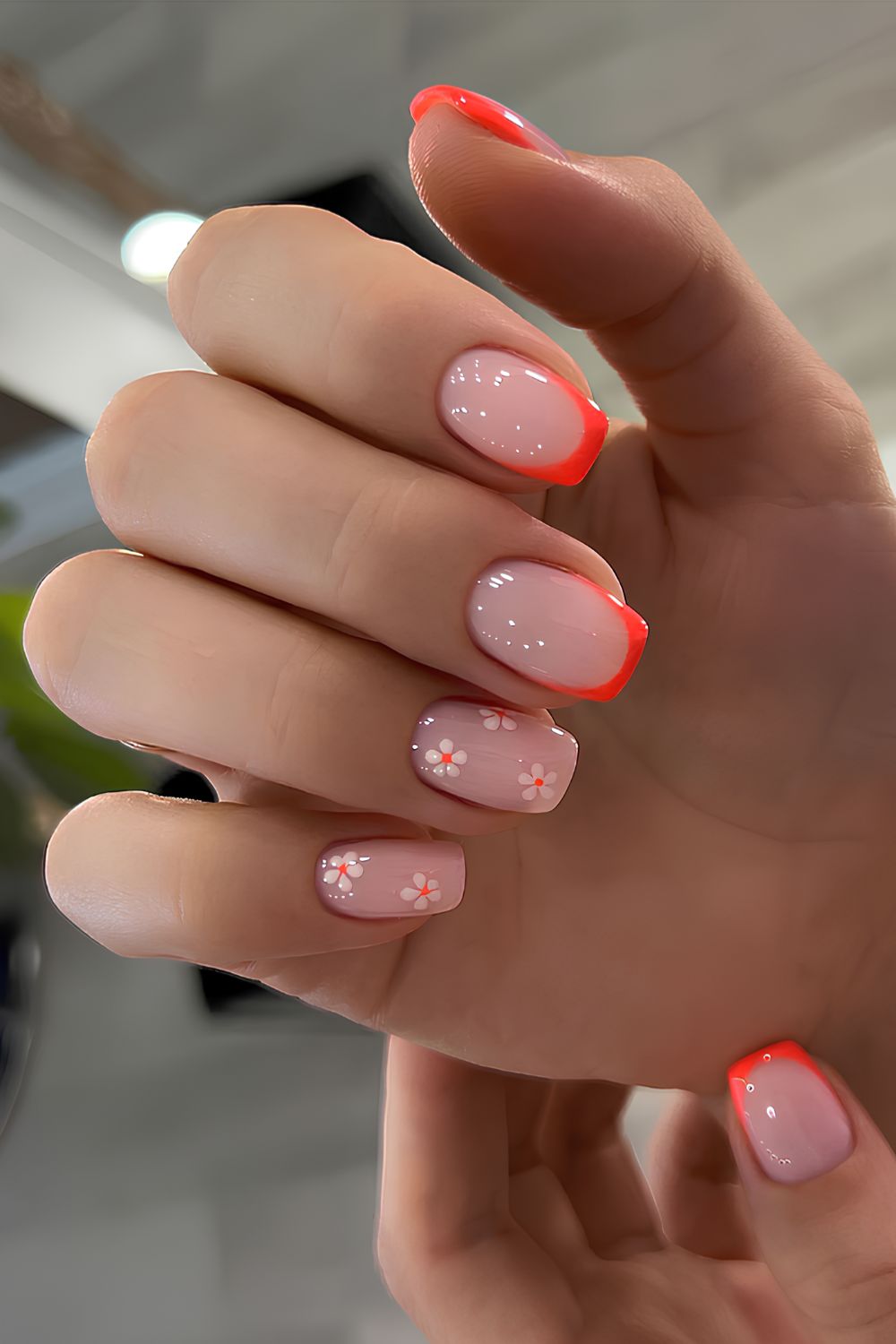 Orange French mani with white flowers