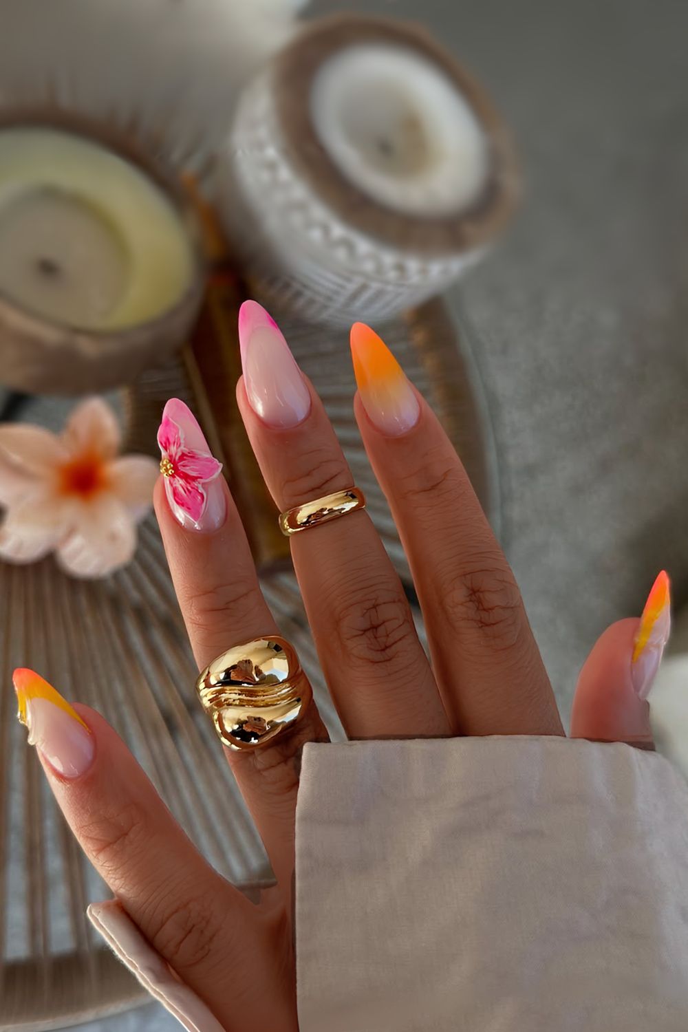 Orange and pink french tips with sculpted flower accent