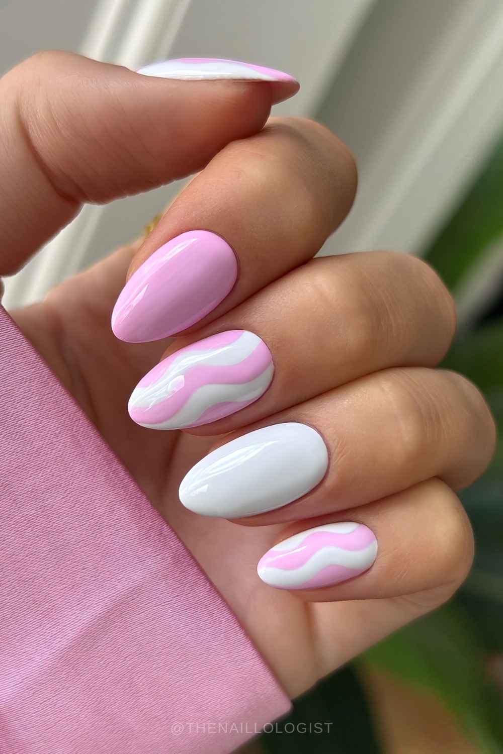 Pink and white nails with swirl art
