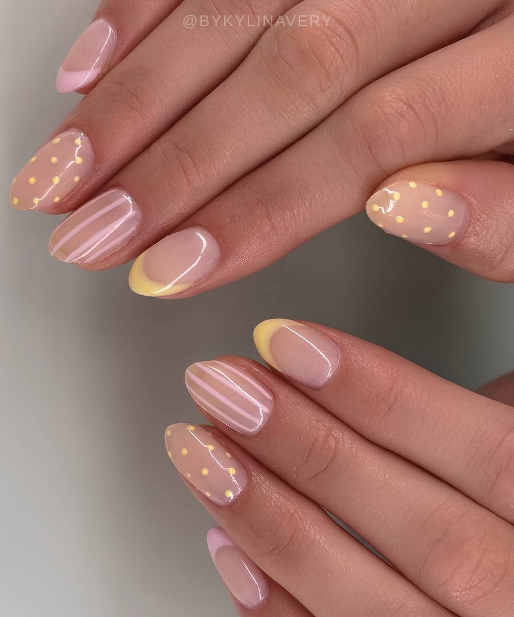 Pink and yellow French nails with stripes and dots