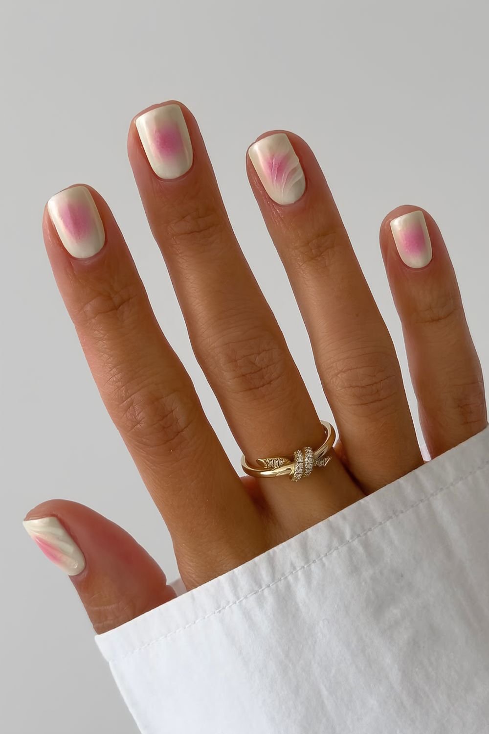 Pink and yellow aura nails with accent swirls