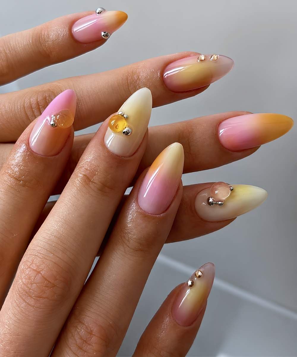 Pink and yellow mani with gems and metallic studs