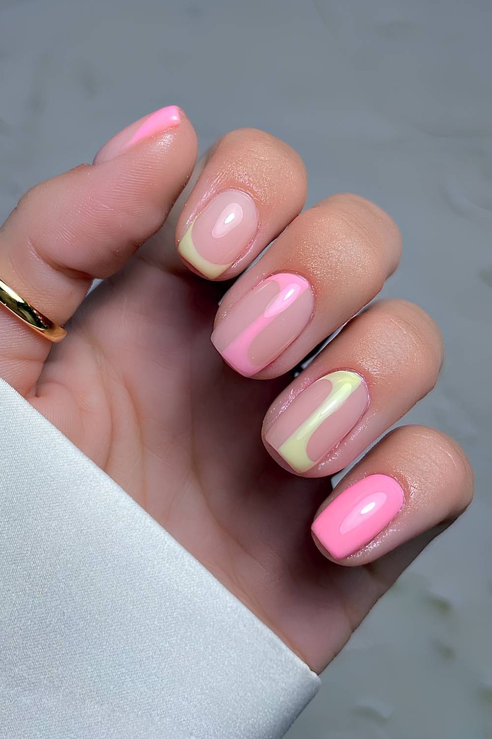 Pink and yellow nails with accent line art