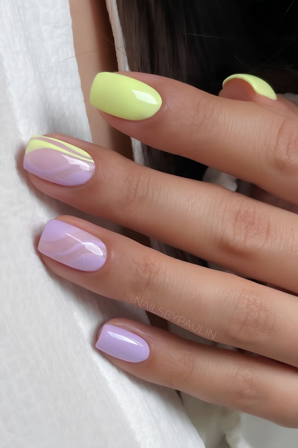 Pink and yellow nails with accent swirls