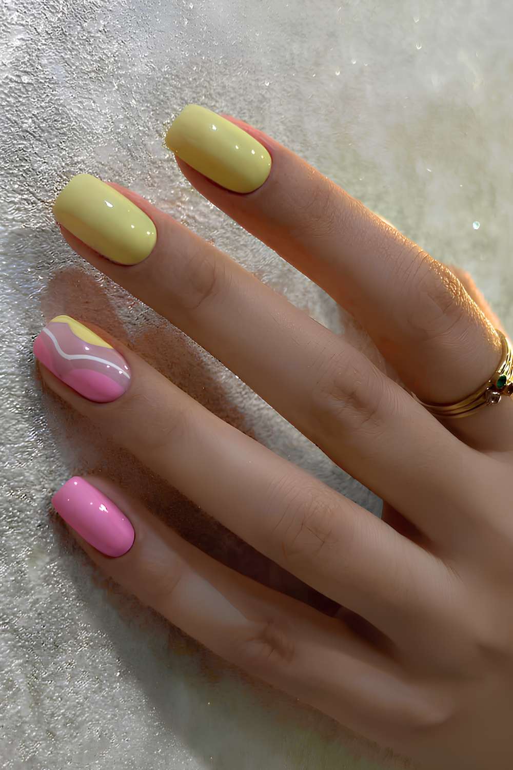 Pink and yellow nails with negative space accent