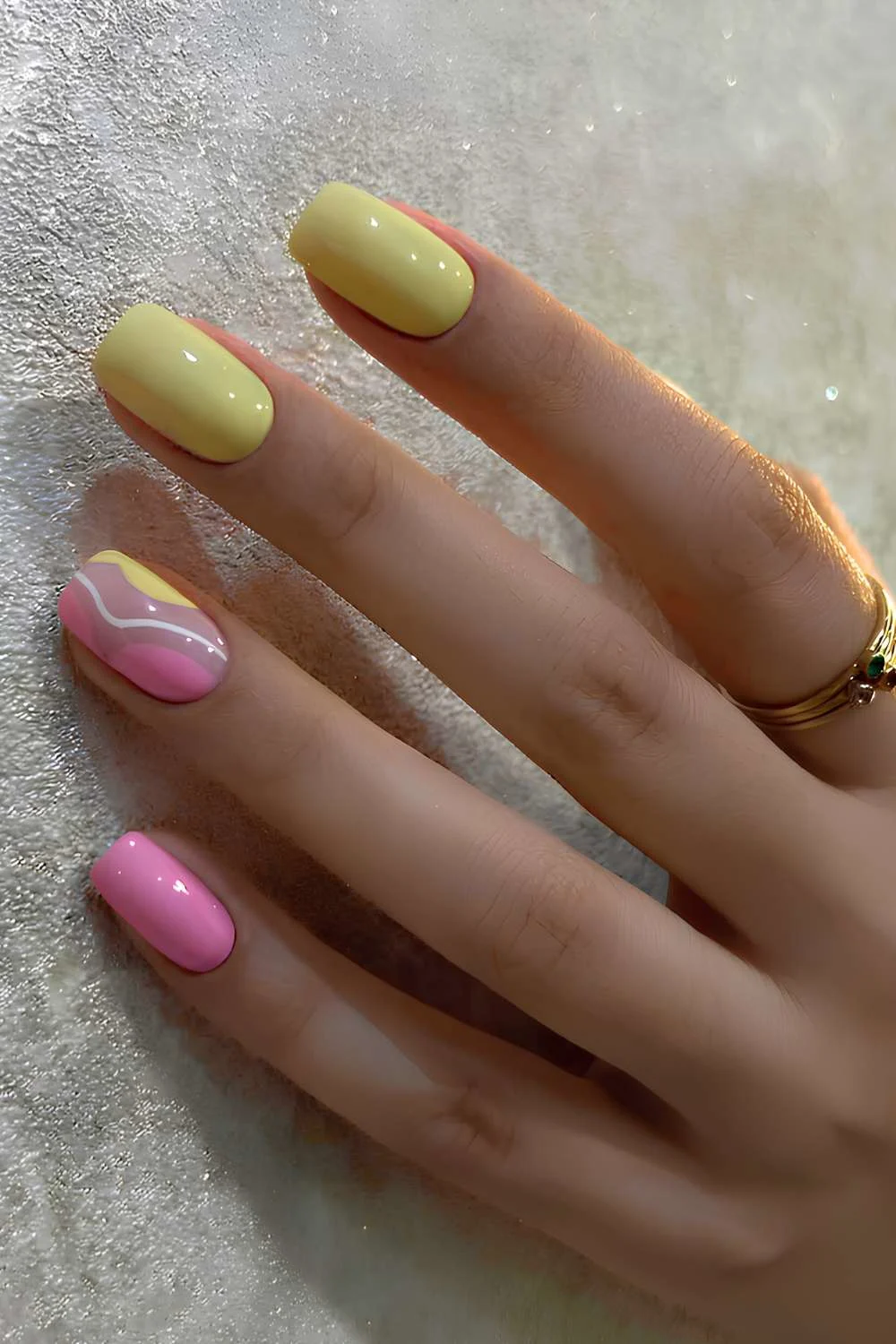 Pink and yellow nails with negative space accent