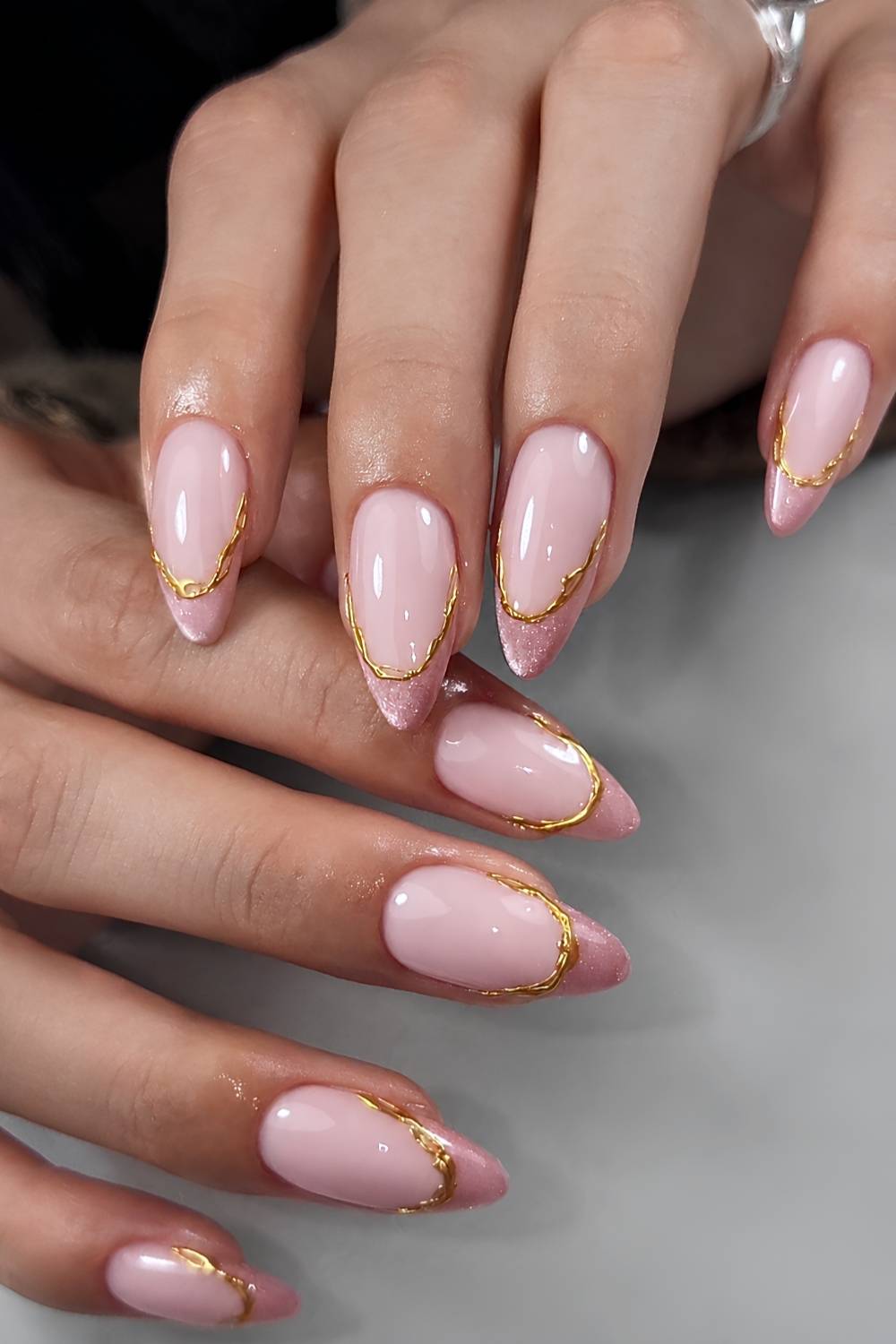Pink cat eye French tips with gold outlines