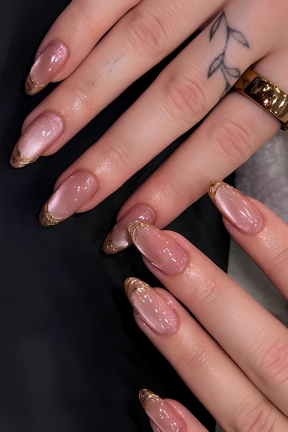 Pink cat eye nails with accent gold French tips