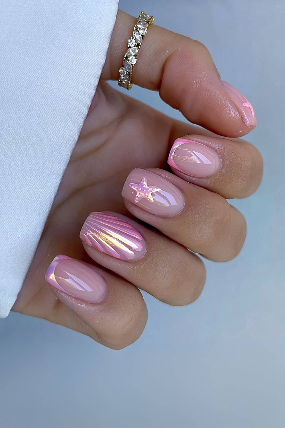 Pink chrome French tips with starfish and seashell design