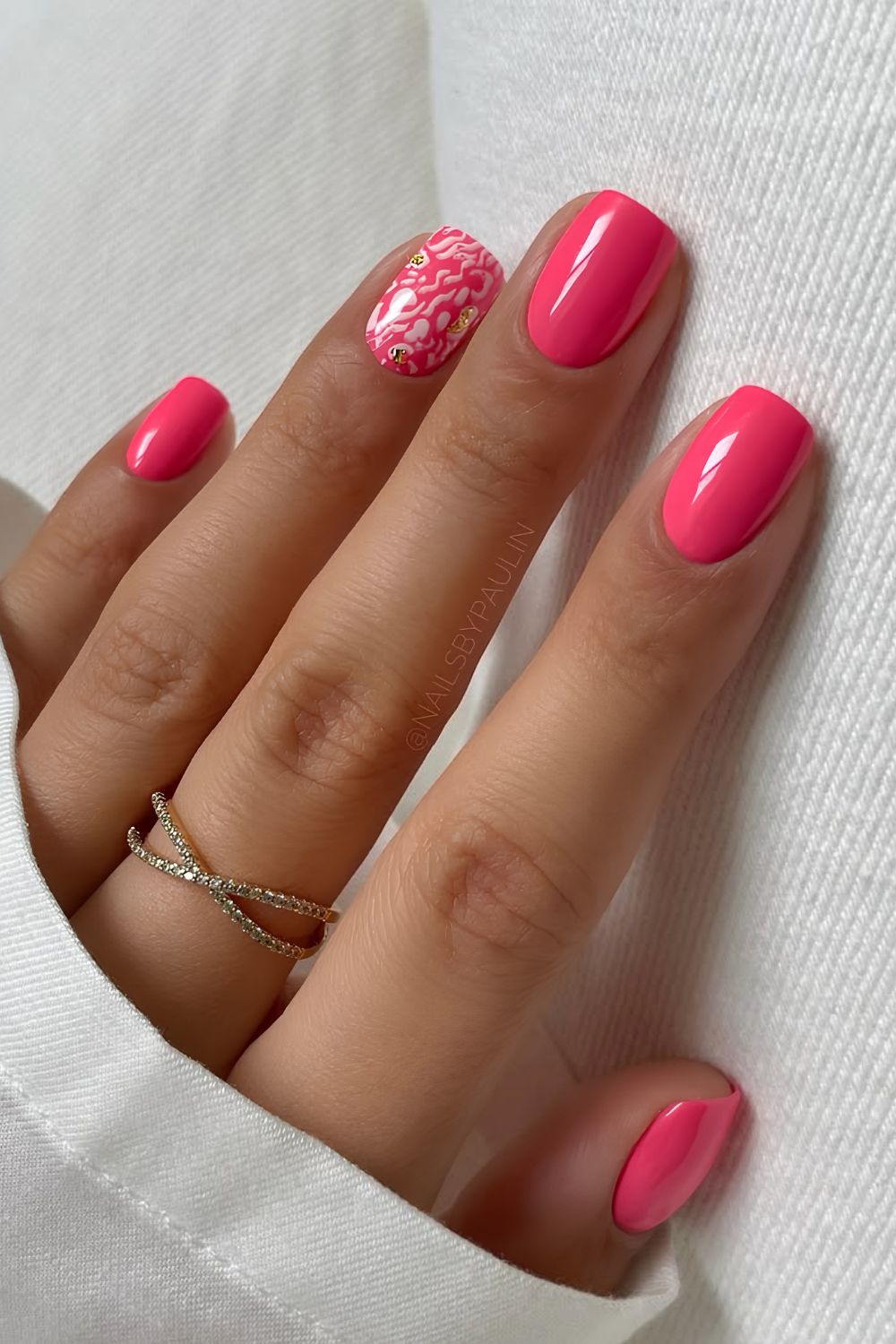 Pink nails with white animal print and gold foil accents