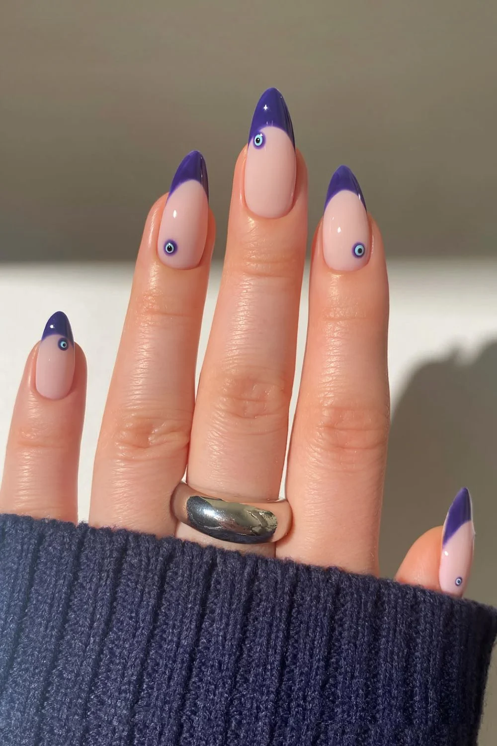 Purple French nails with evil eye accents