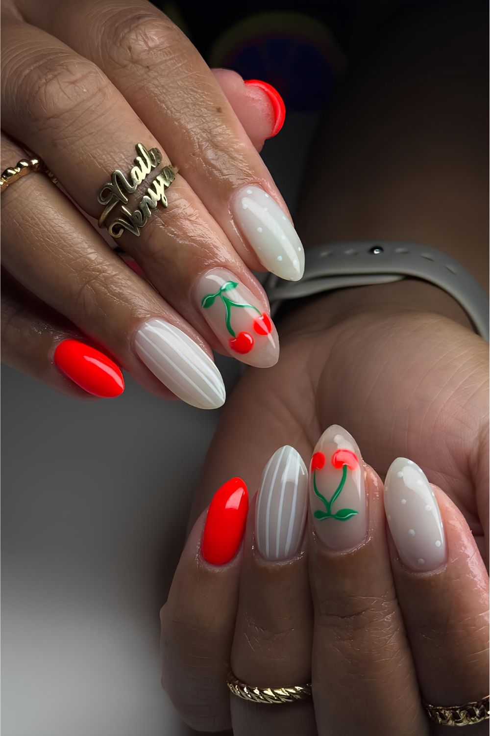 Red and white nails with stripes, dots and cherry accents
