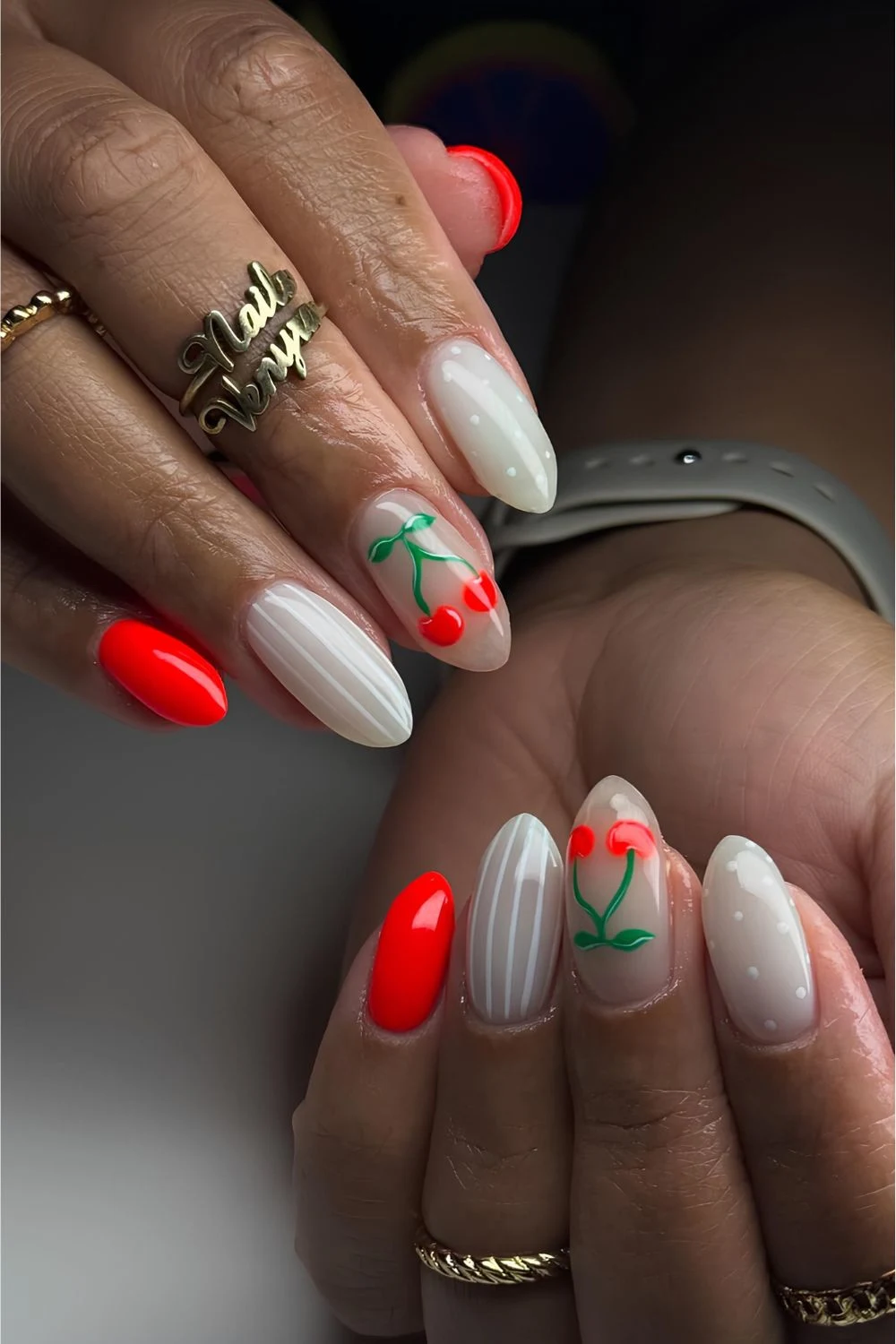 Red and white nails with stripes, dots and cherry accents