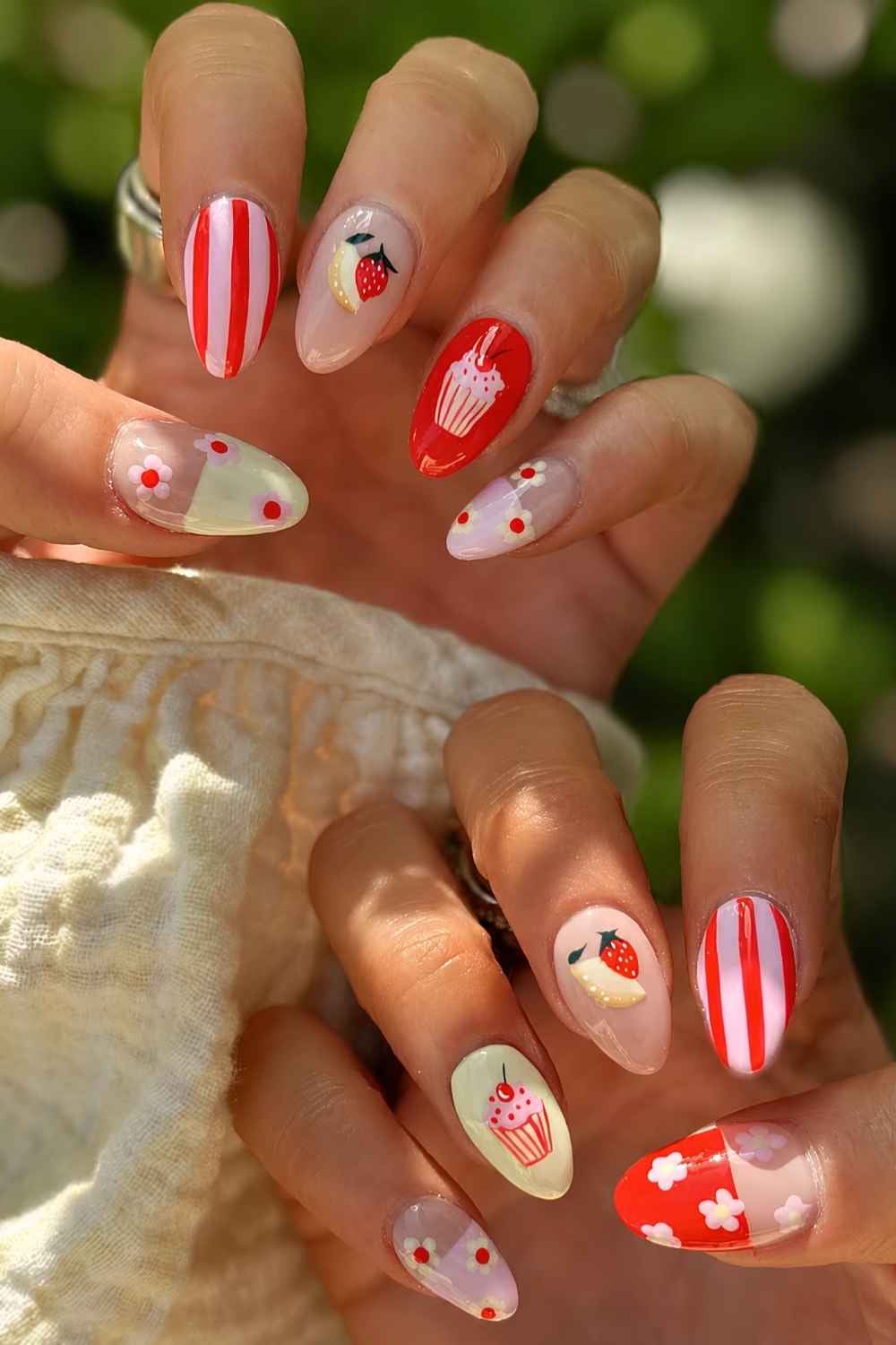 Red and yellow mani with fruit and cupcake art