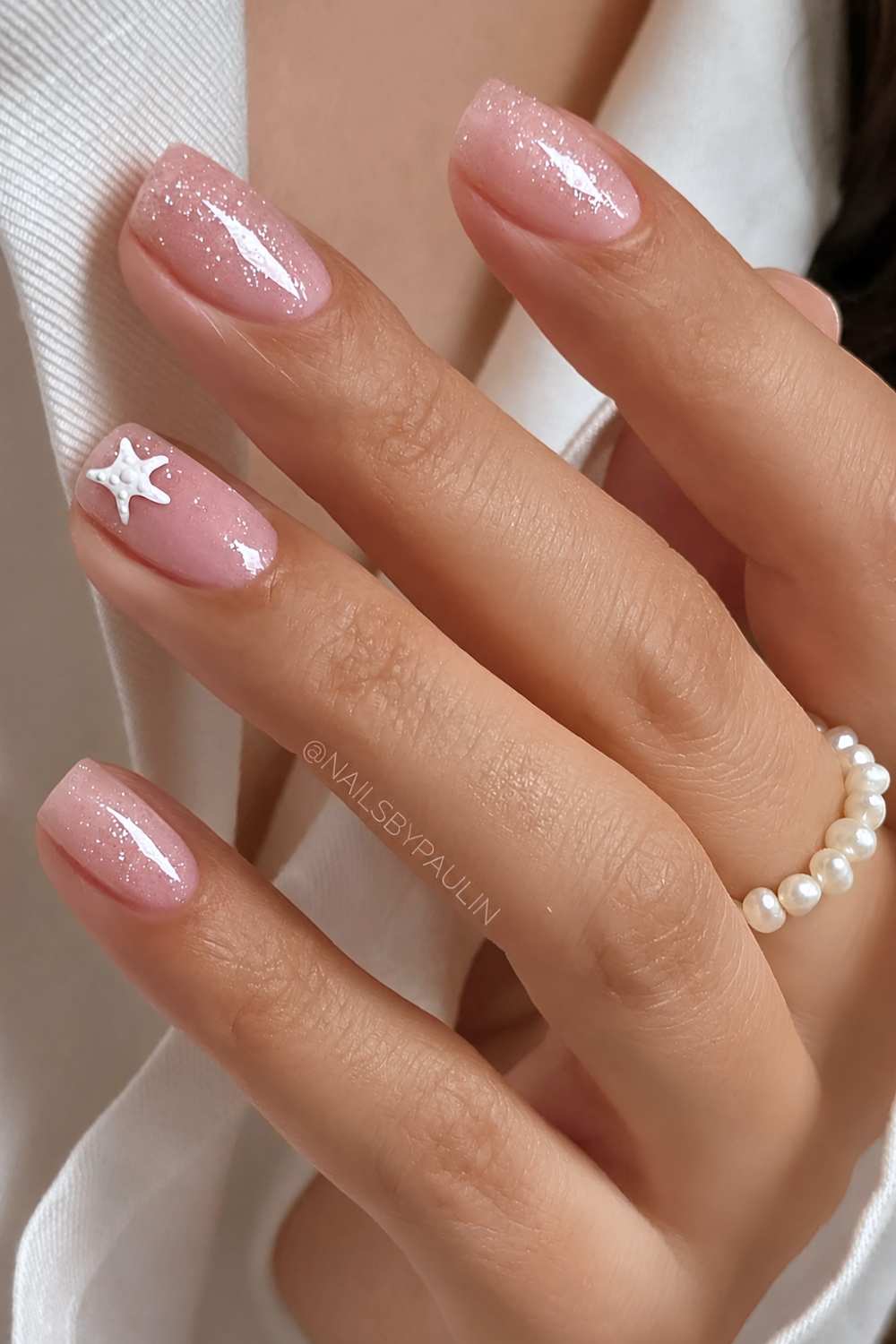 Sheer glittery nails with starfish accent