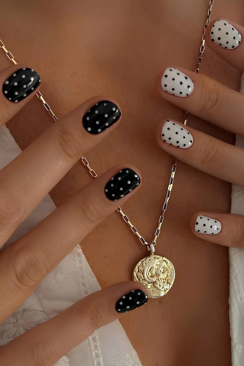 Short black and white polka dot manicure