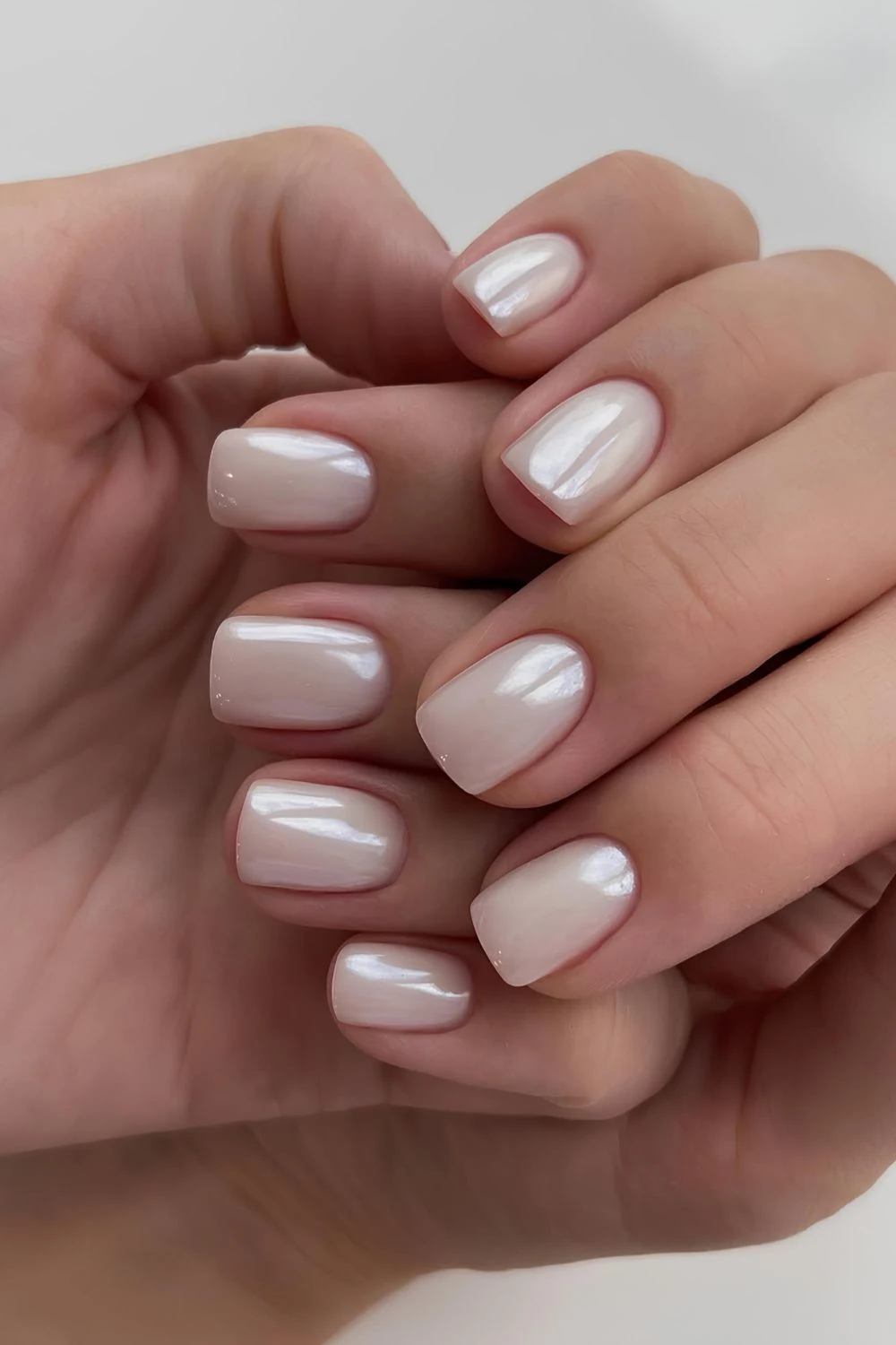 Short white pearl chrome manicure