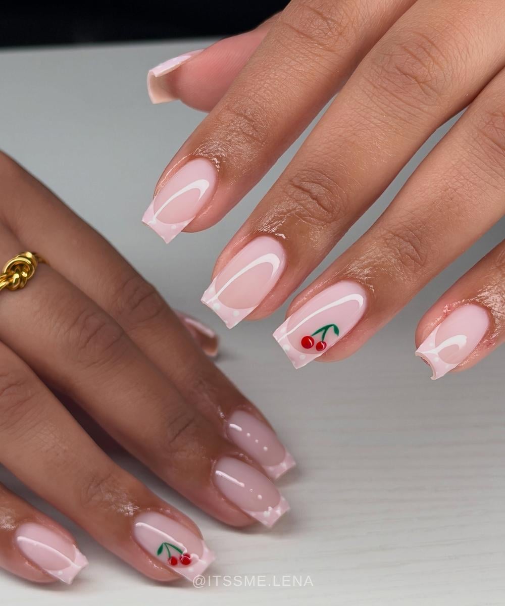 Square pink French French nails with dots and cherries
