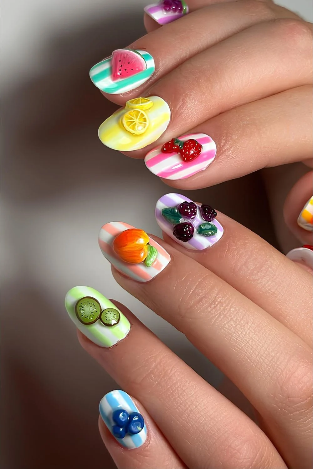 Striped colorful nails with 3d fruit accents