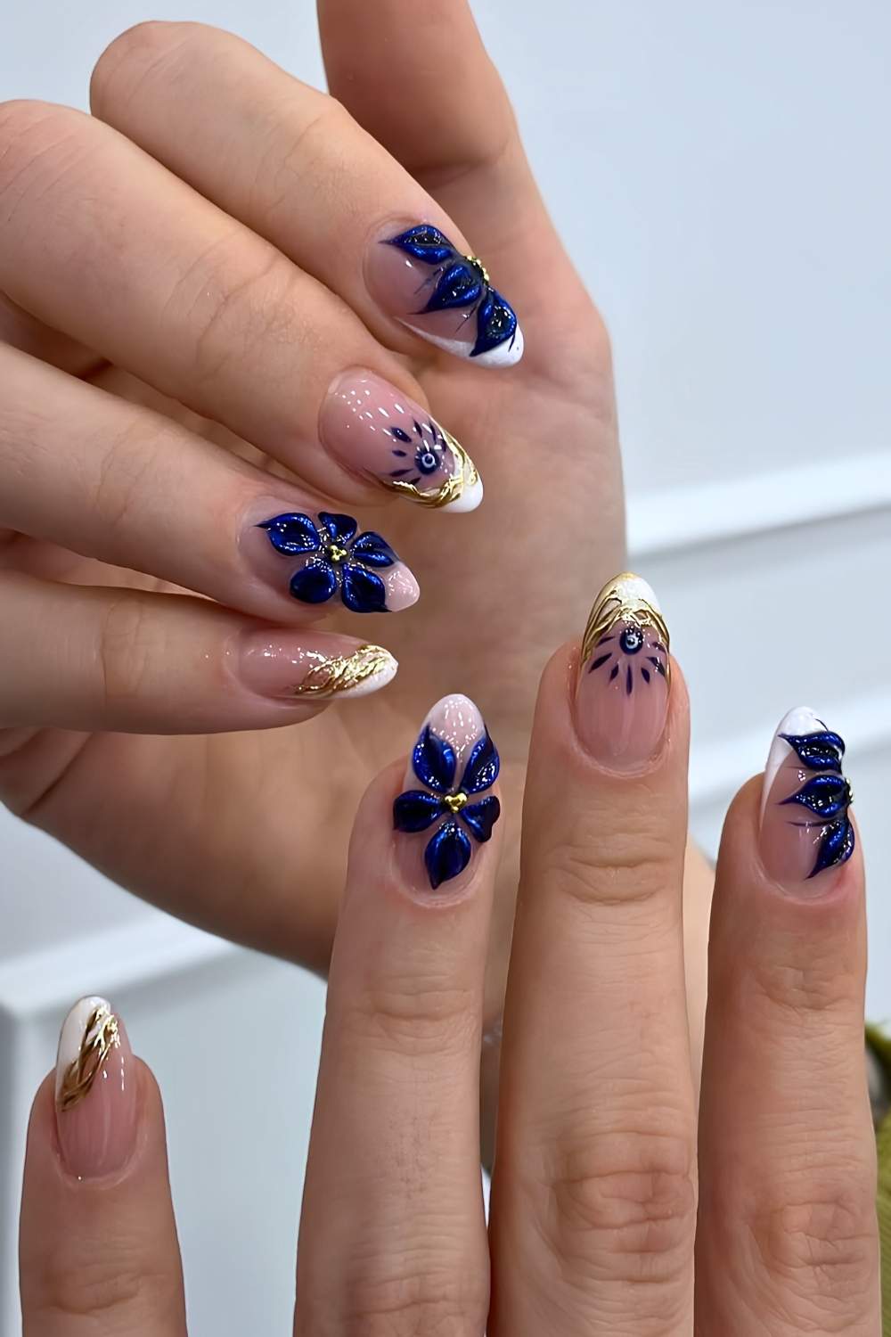 White French mani with blue florals and nazars