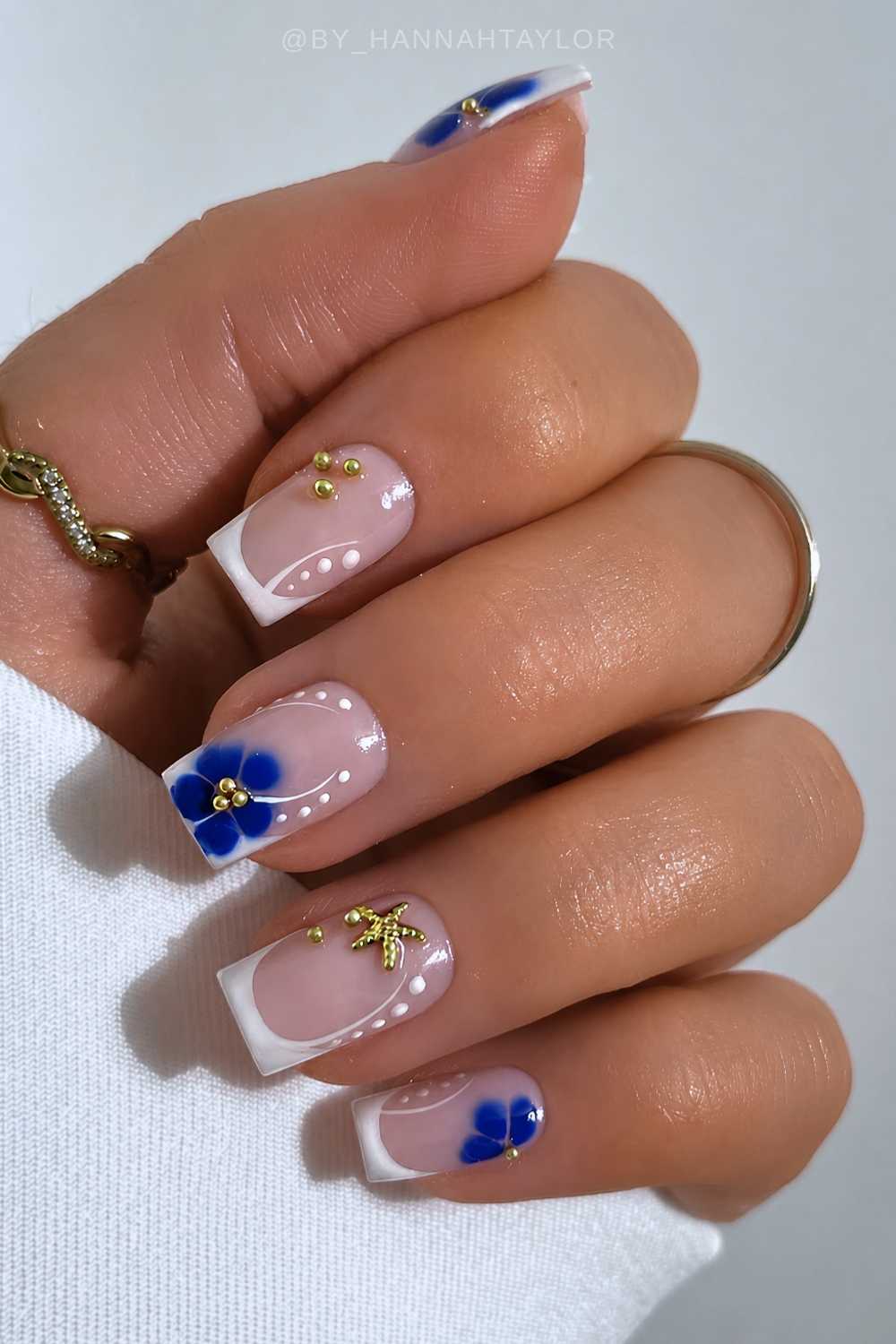White French nails with starfish and blue flowers