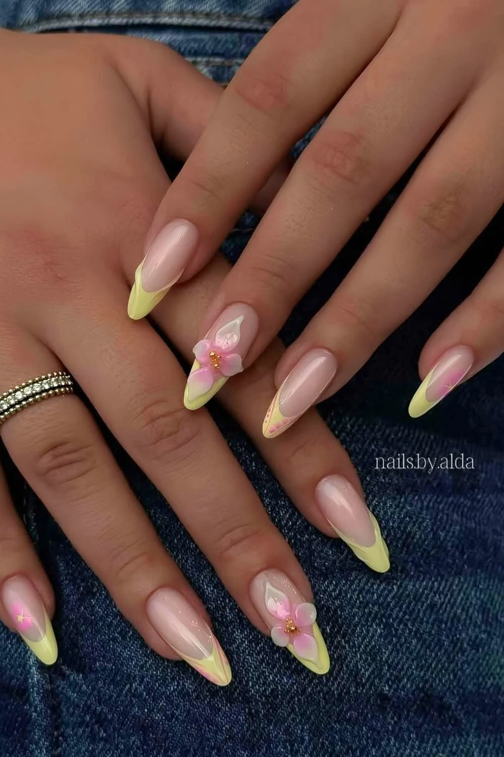 Yellow French mani with pink sculpted flowers