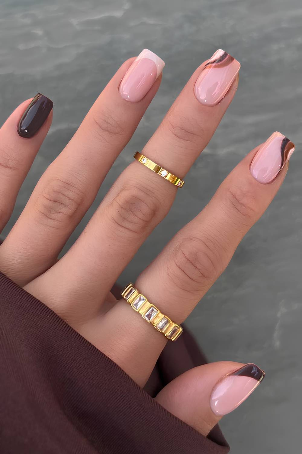 Beige and brown nails with accent swirls