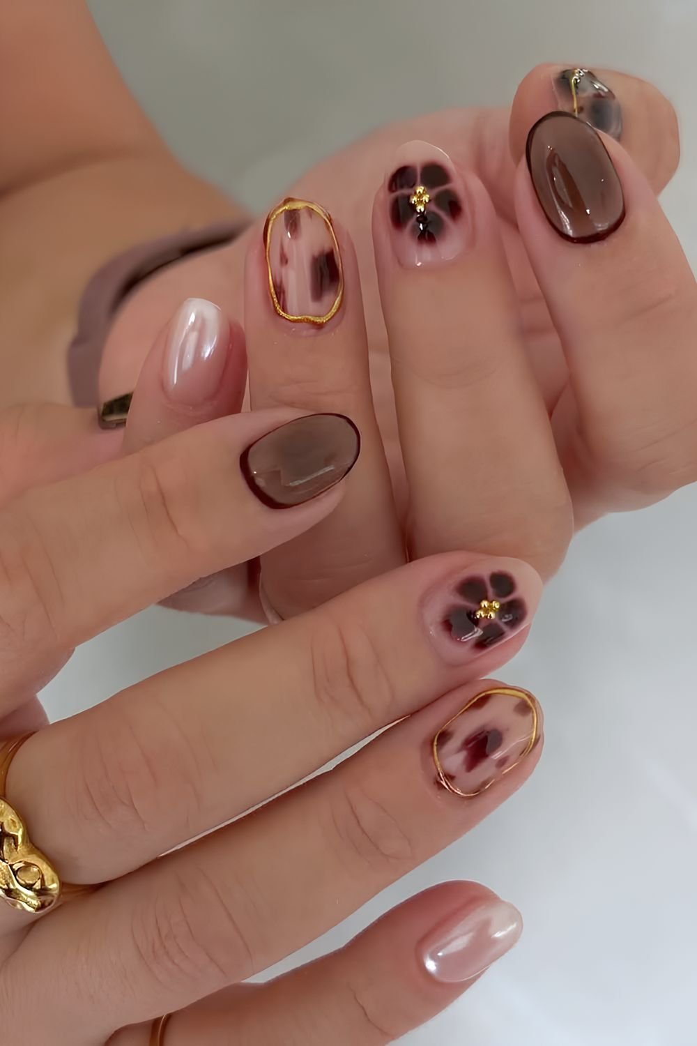 Brown mix and match design on short nails