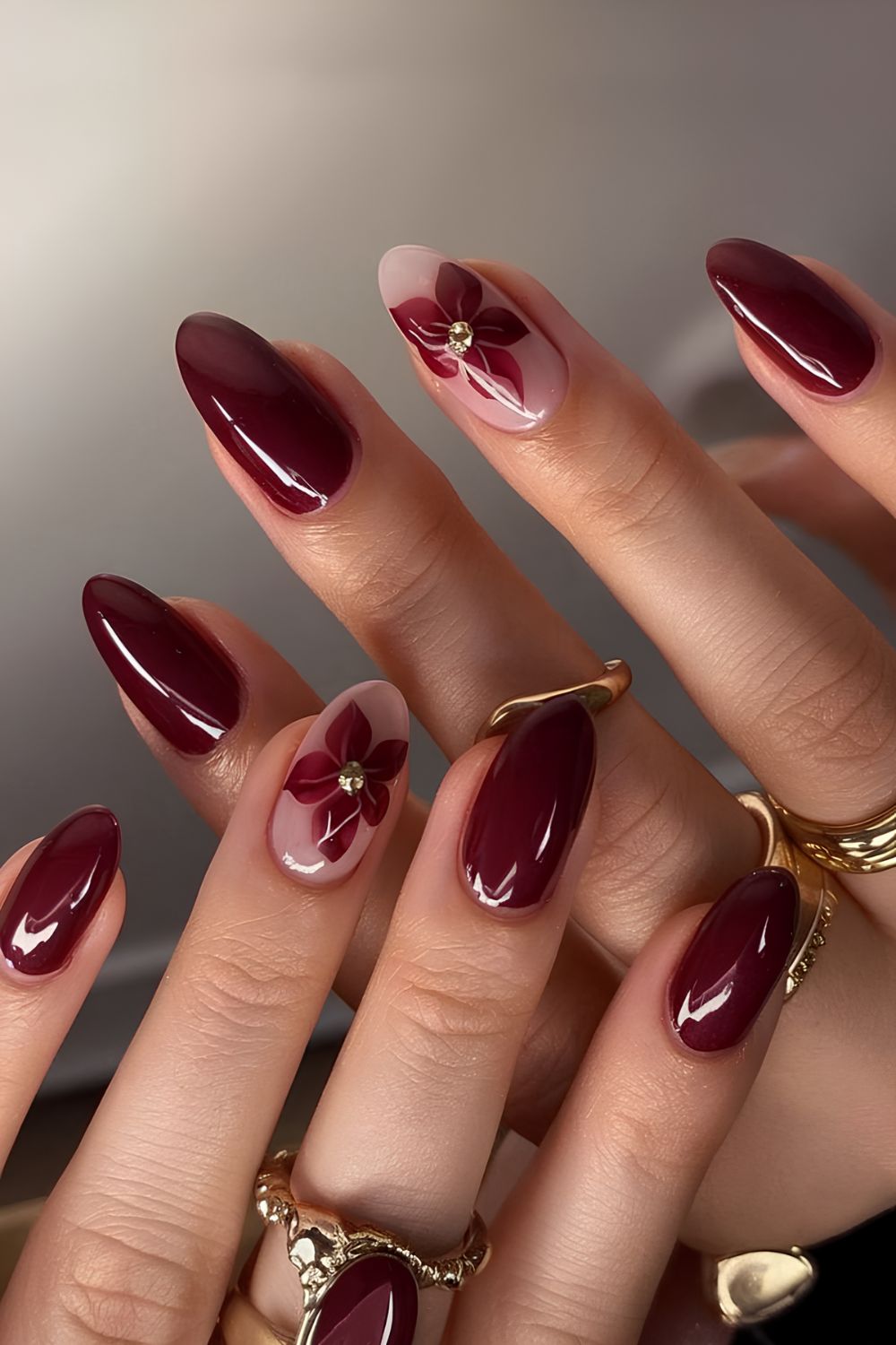 Burgundy manicure with flower accent nails