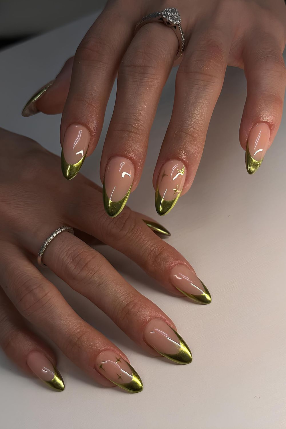 Green chrome French tip nails with tiny stars