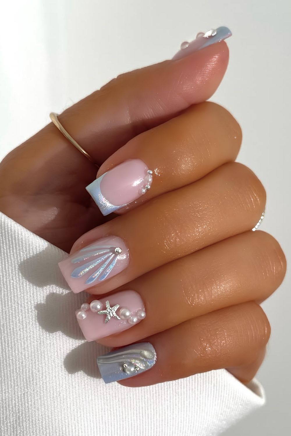 Light blue mermaid inspired nails with chrome finish