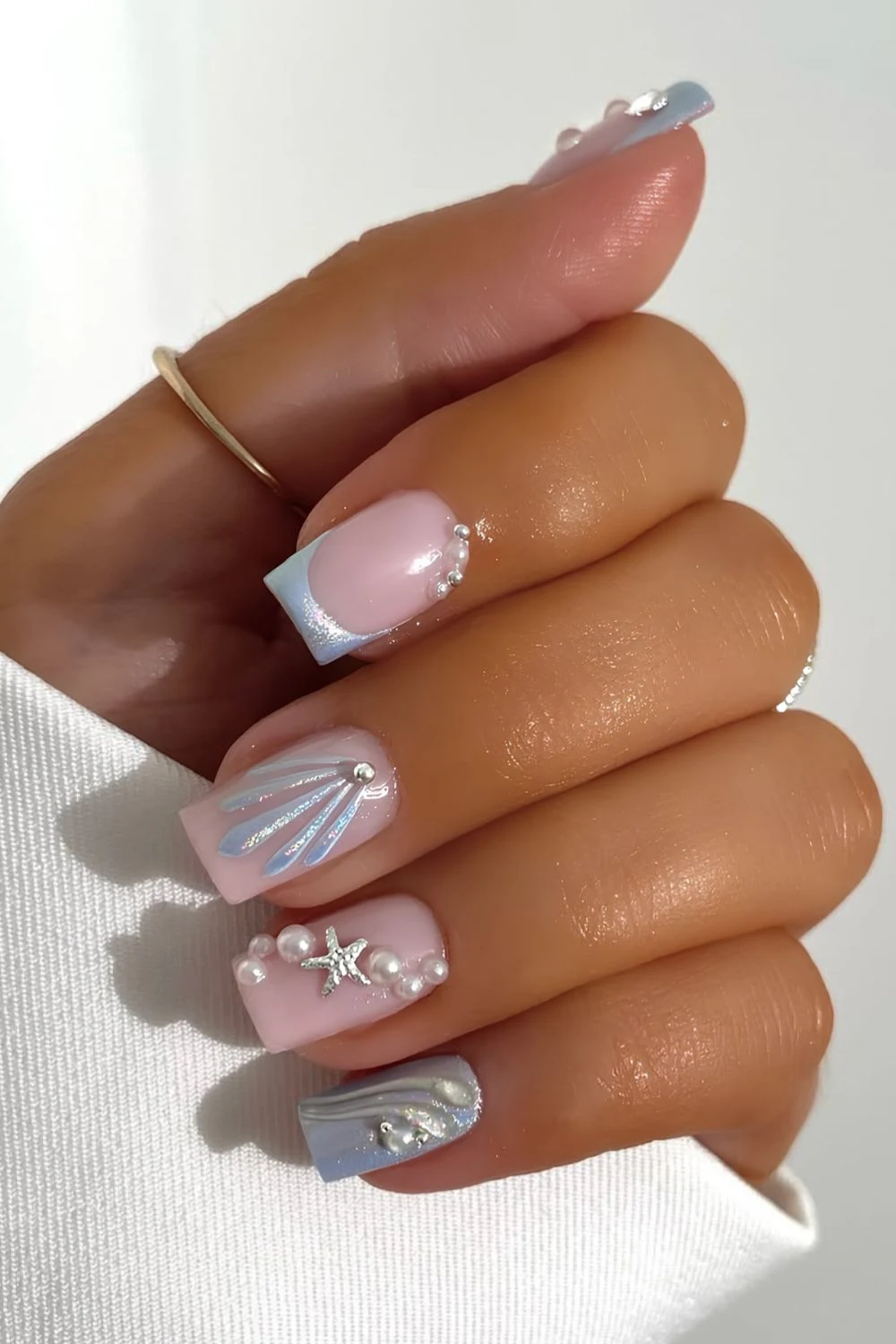 Light blue mermaid inspired nails with chrome finish