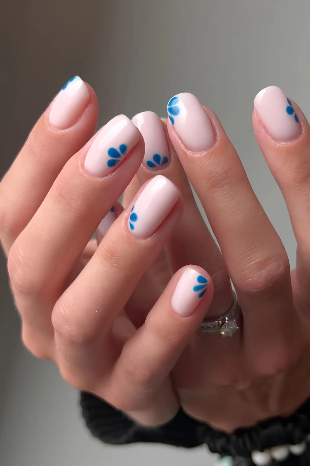 Light pink BIAB nails with dark blue half florals