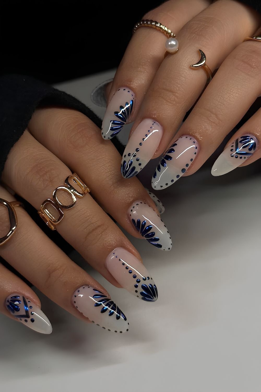 Milky almond nails with navy blue chrome florals