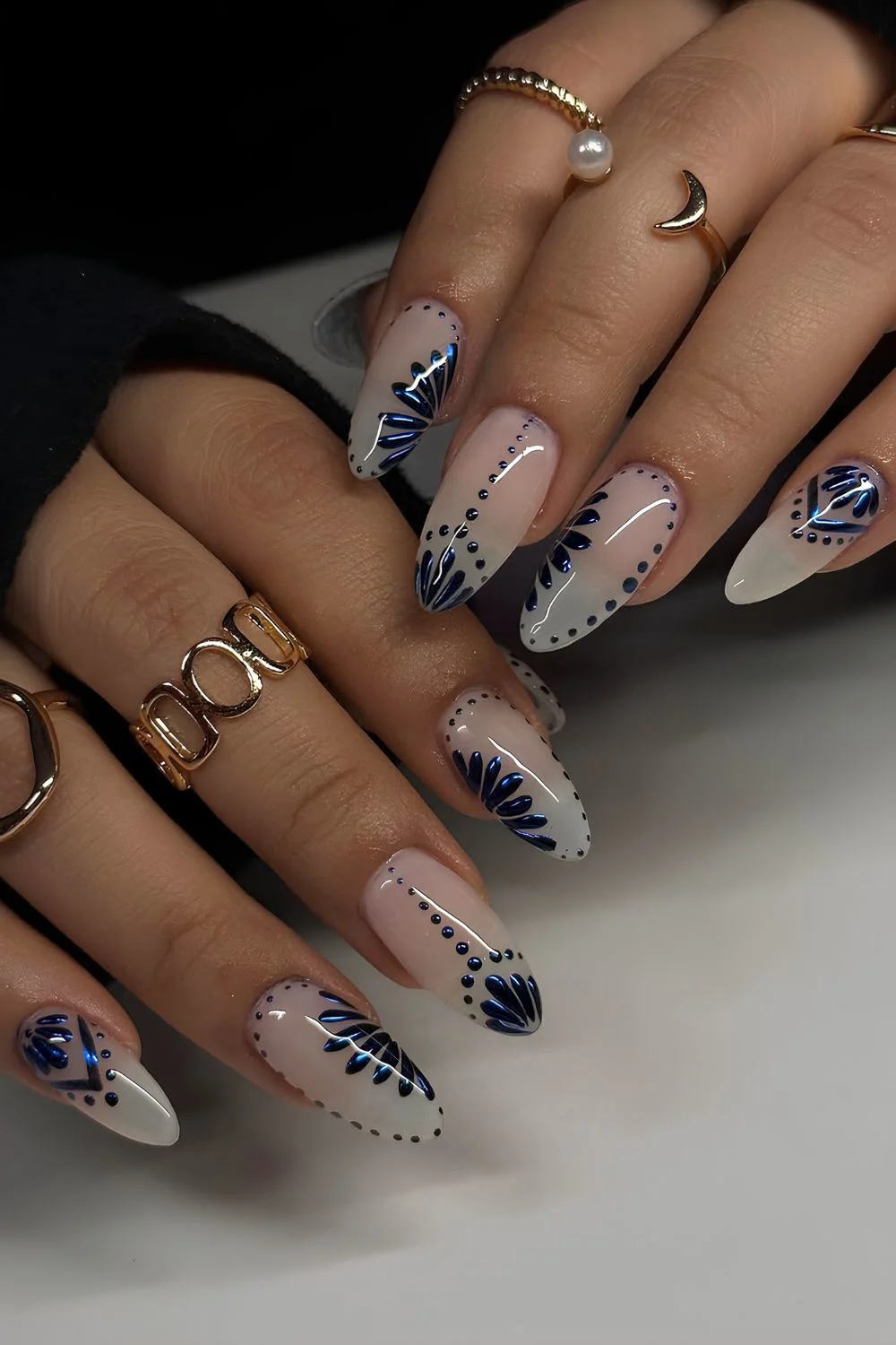 Milky almond nails with navy blue chrome florals