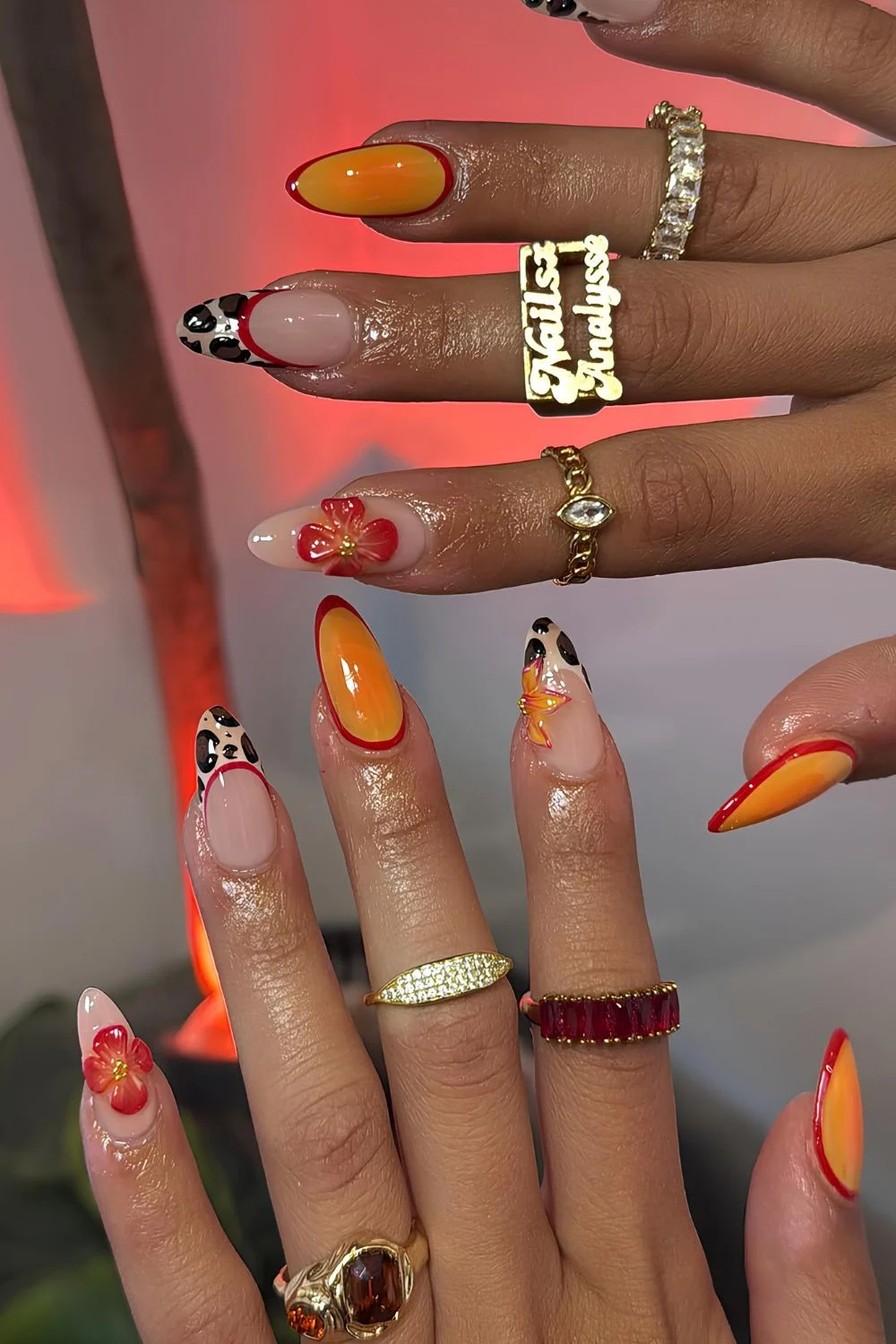 Orange mani with animal print tips and floral accents