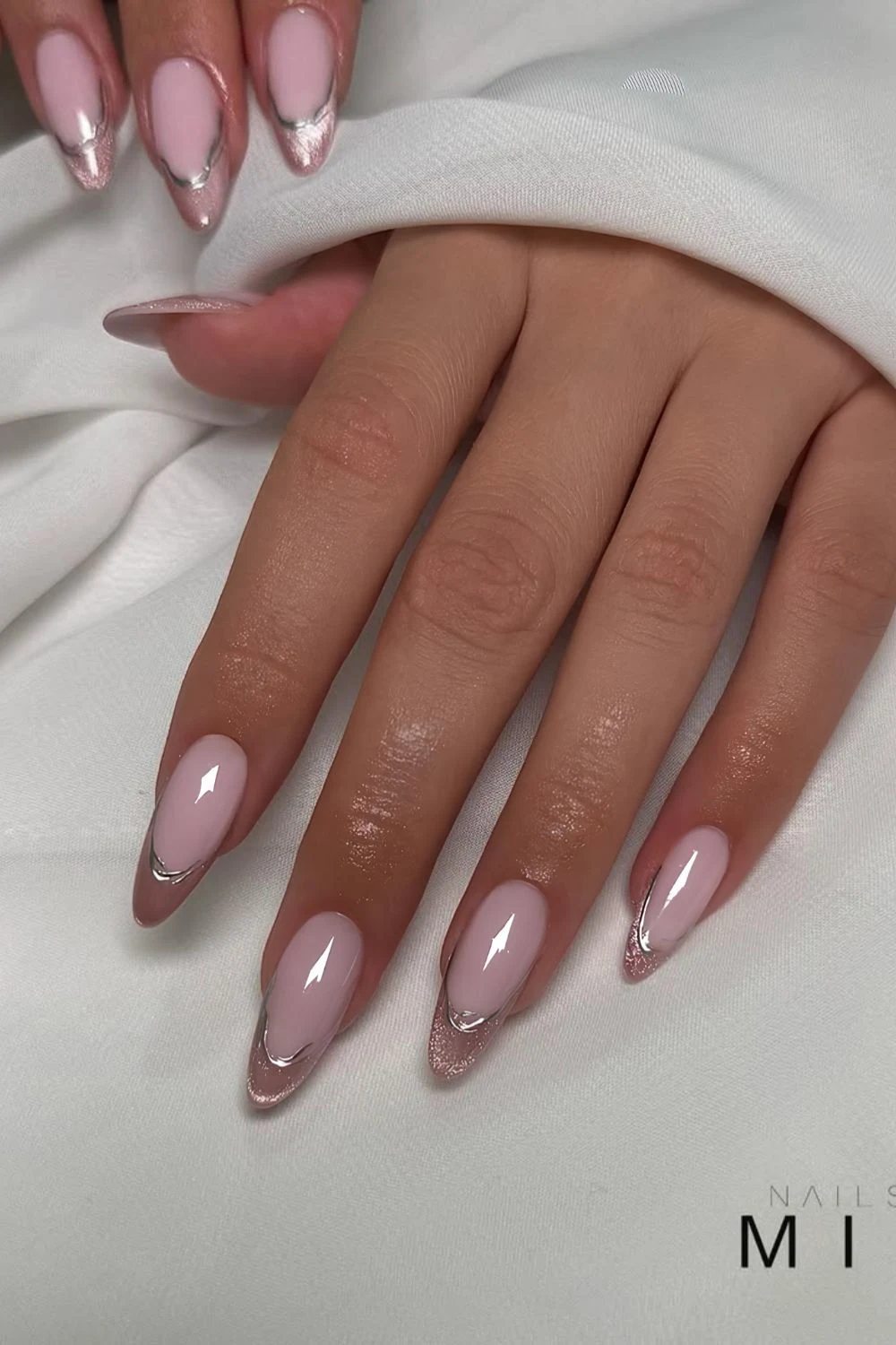Pink cat-eye French nails with silver chrome outlines