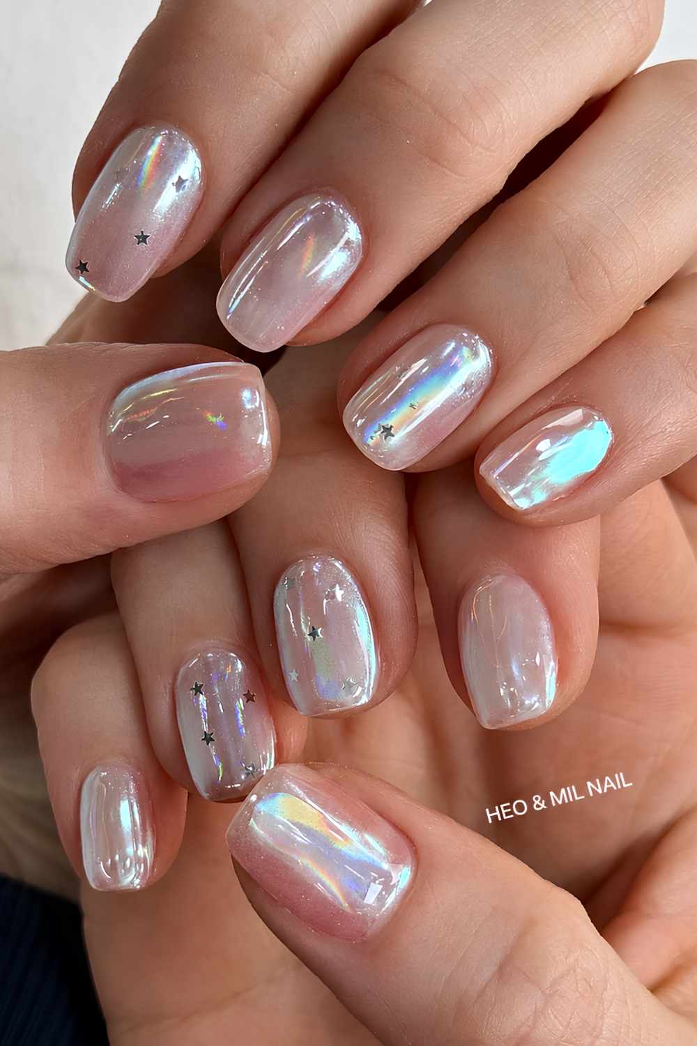 Short aurora chrome nails with micro stars