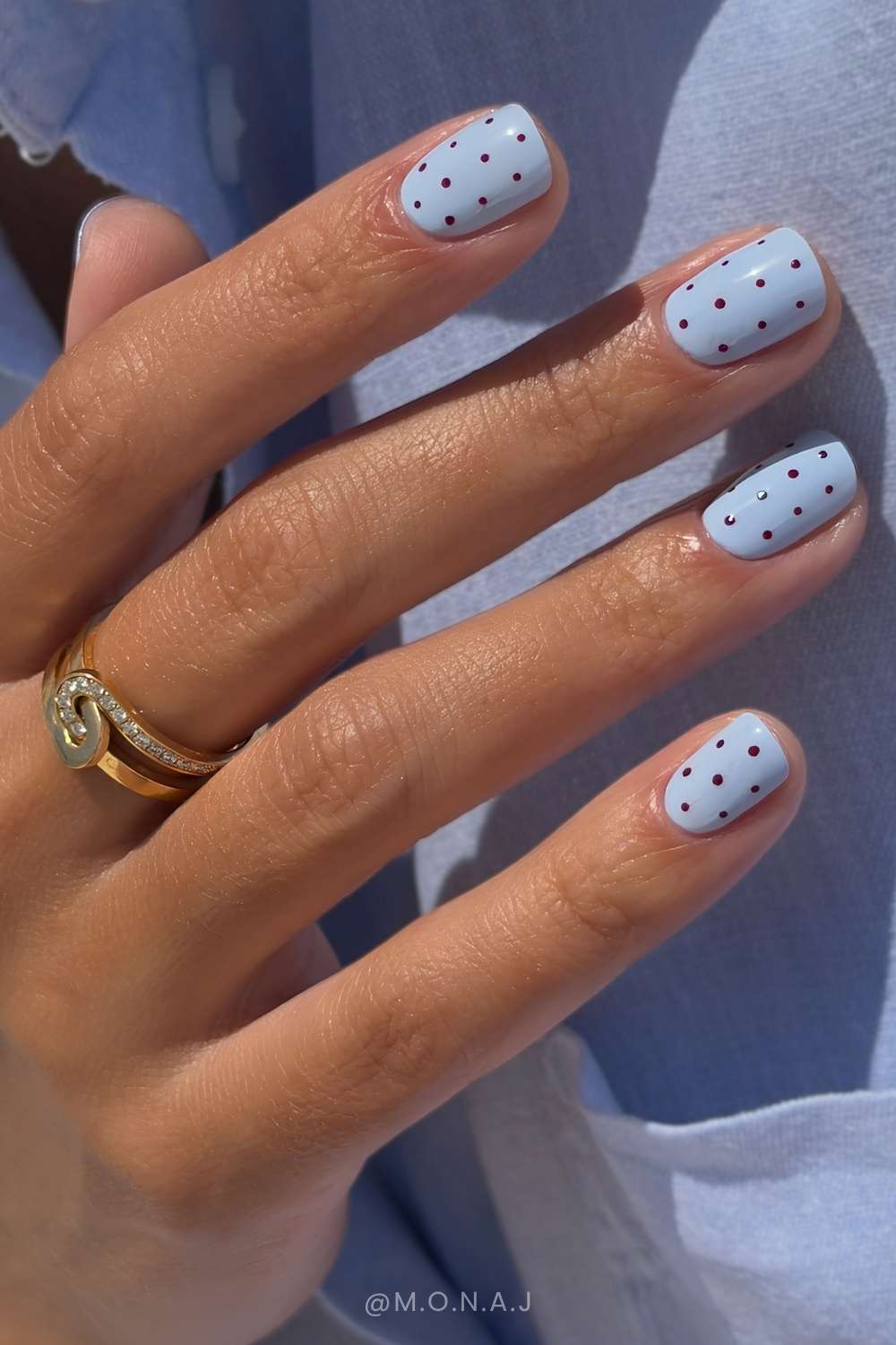Short blue nails with brown polka dots