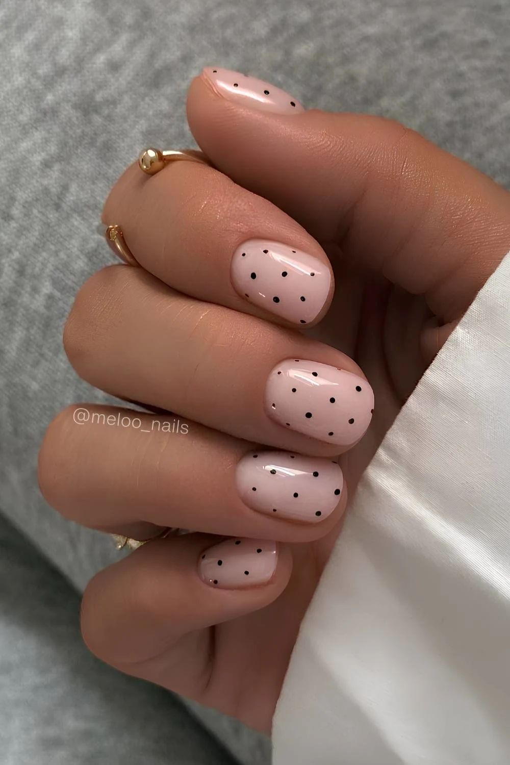 Short milky white nails with black polka dots