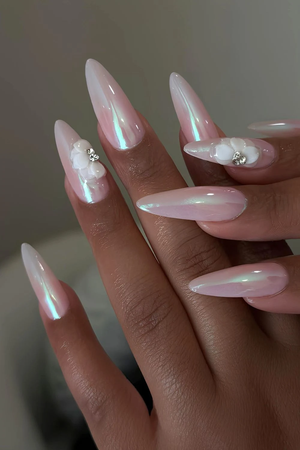 White chrome nails with aurora effect and 3d florals