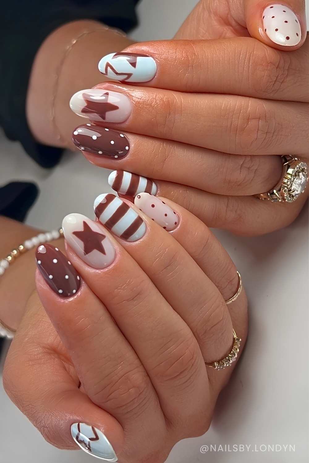 brown and blue nails with mixed pattern art